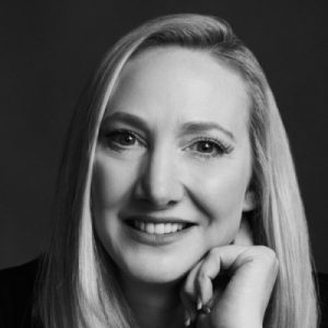 Photo of Joanne. A woman with blonde hair, smiling at the camera.
